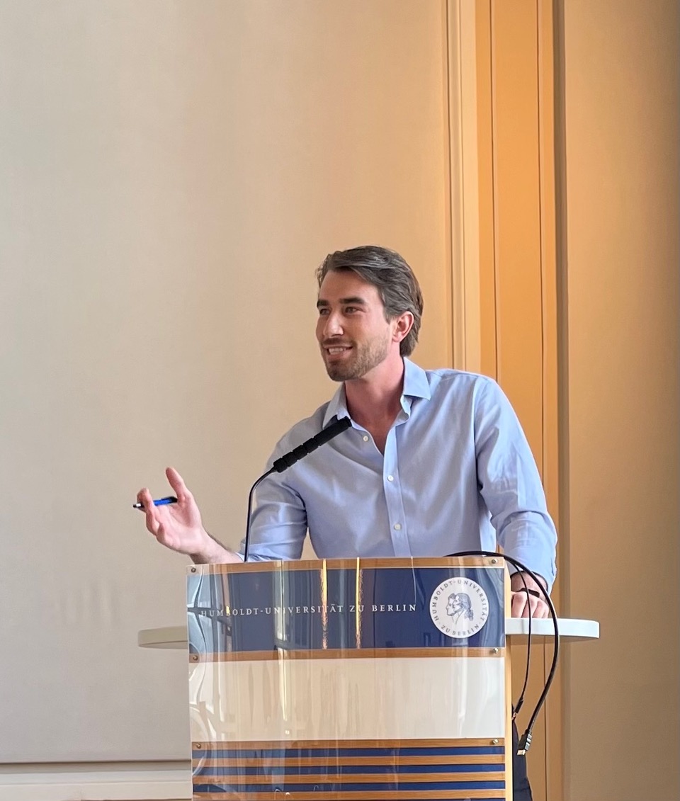 '23 Ph.D. graduate Creighton Coleman presenting a paper at a conference.